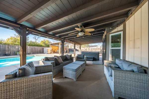 a view of a swimming pool with lawn chairs and a yard