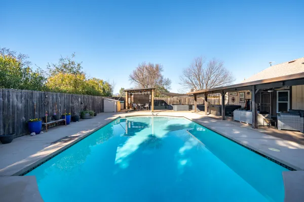 a view of a swimming pool with a lounge chair