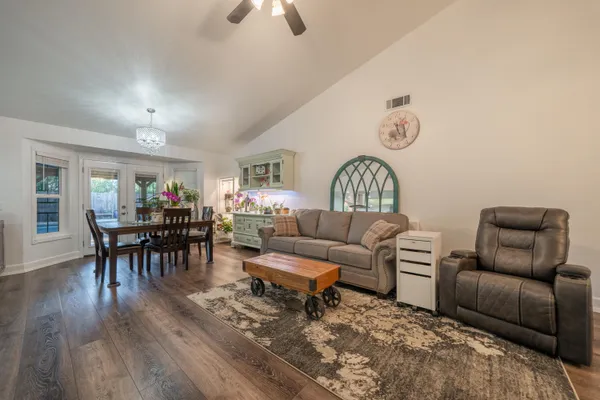a dining room with furniture and wooden floor