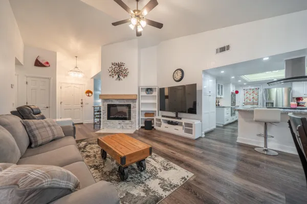 a kitchen with granite countertop a sink cabinets stainless steel appliances and a counter top space