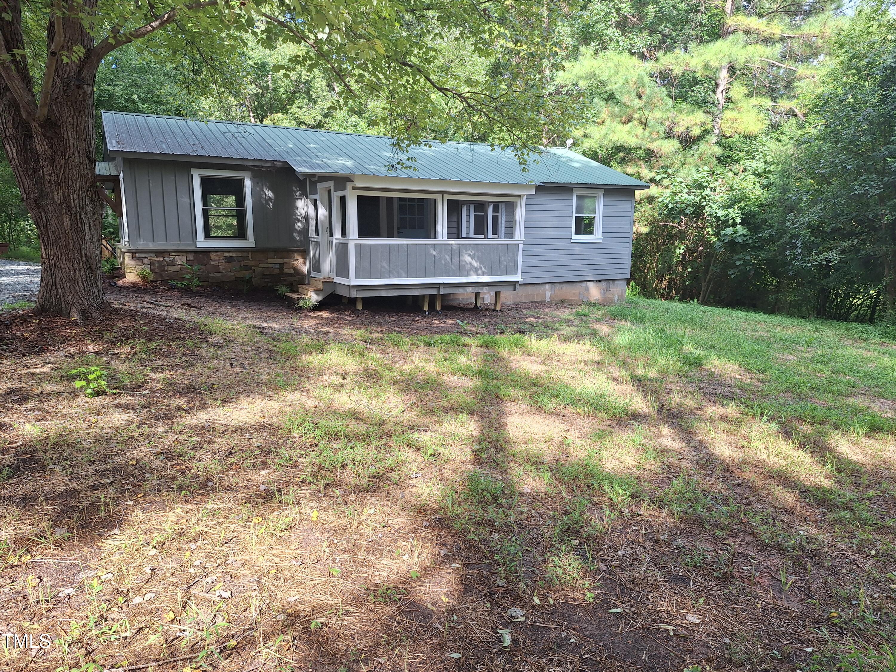 a front view of house with yard and trees