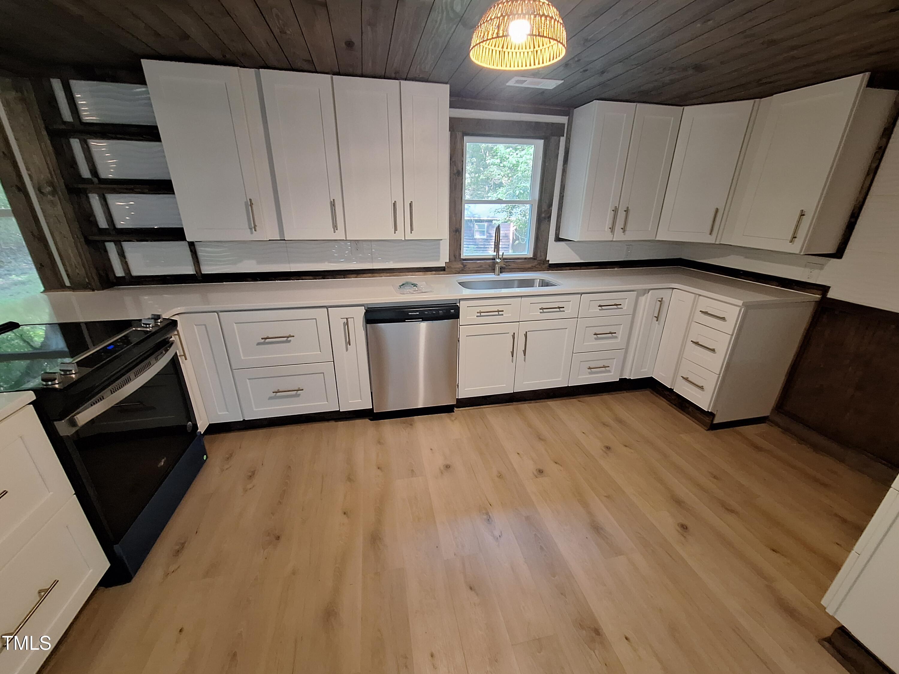 12 Nota Road Moncure, NC 27559 - Photo 14 of 30 a kitchen with wooden floors and white appliances