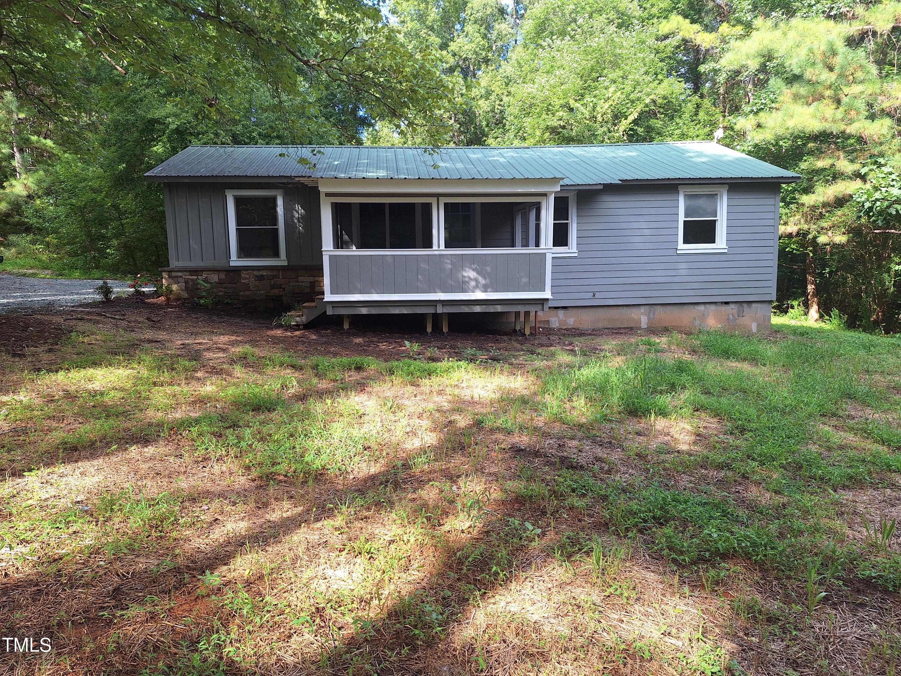 12 Nota Road Moncure, NC 27559 - Photo 25 of 30 a backyard of a house with yard and outdoor seating