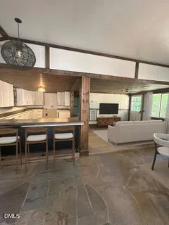 a living room with stainless steel appliances kitchen island granite countertop furniture and a kitchen view