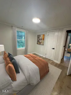 a bedroom with a bed and a window