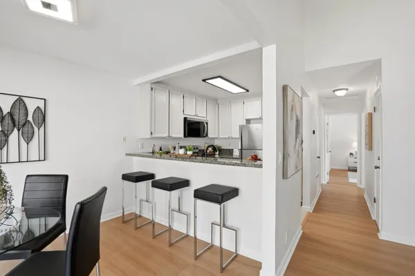 a kitchen with kitchen island wooden cabinets and refrigerator