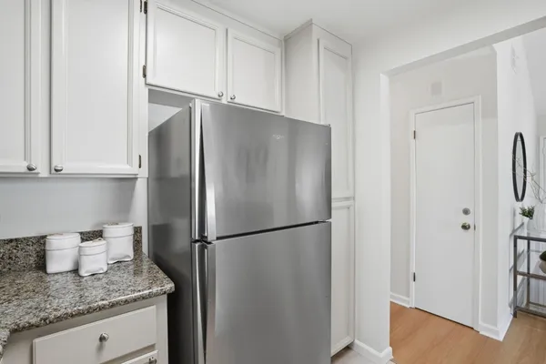 a kitchen with stainless steel appliances granite countertop a refrigerator and a granite counter tops