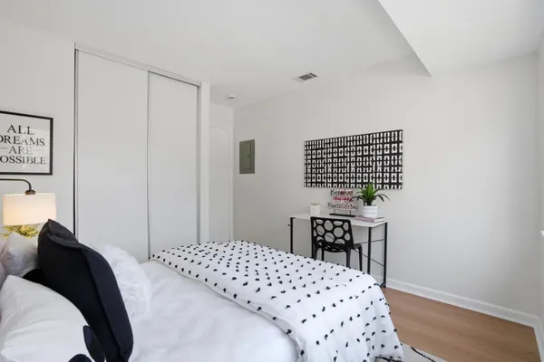 a bedroom with a bed and a table