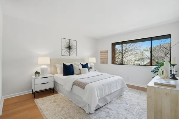 a bedroom with a large bed and a window
