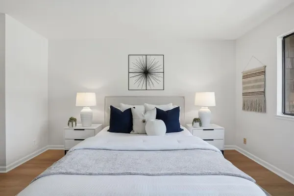 a bedroom with a bed and a night stand
