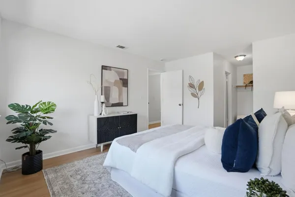 a bedroom with a bed potted plant and a window
