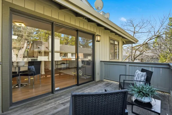 a outdoor living room with furniture and a potted plant