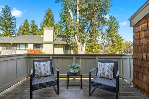a view of a two chairs in the balcony