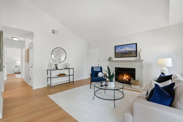 a living room with furniture and a fireplace