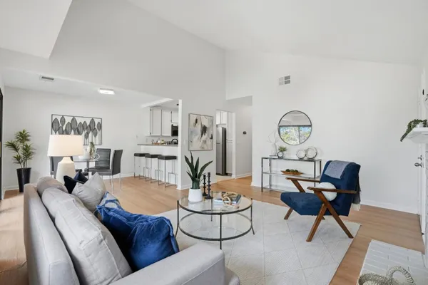 a living room with furniture and wooden floor