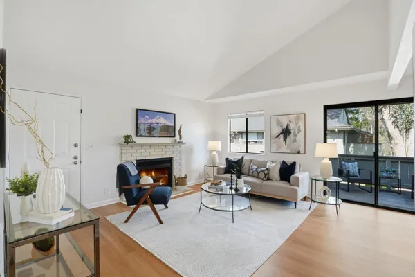 a living room with furniture fireplace and window