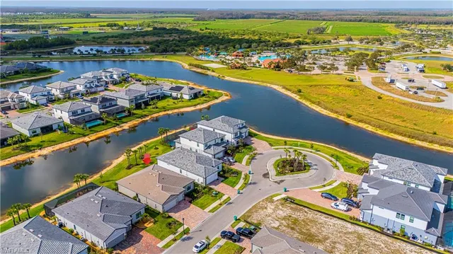 an aerial view of residential houses with outdoor space and swimming pool
