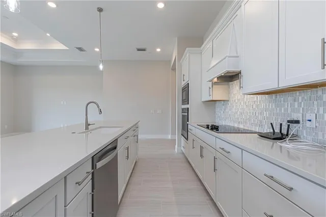 a kitchen with a sink a stove and cabinets