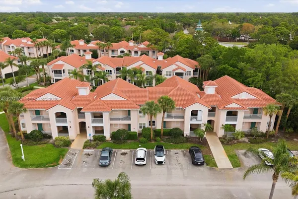 an aerial view of multiple houses with a yard