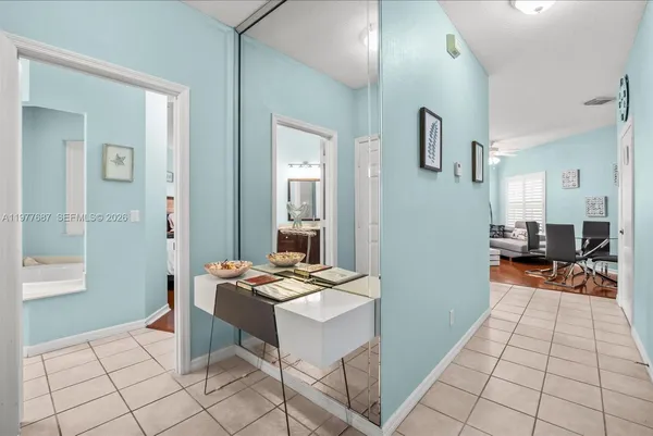 a room with stainless steel appliances kitchen island granite countertop furniture and a view of living room
