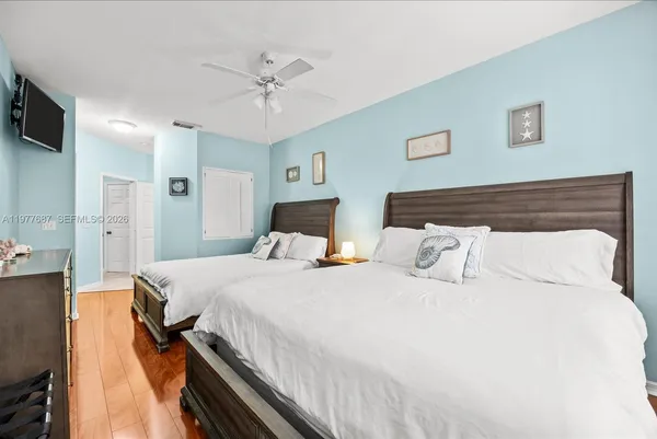 a bedroom with a bed and a night stand