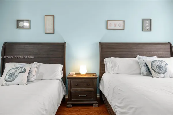 a bedroom with a bed and a painting on the wall