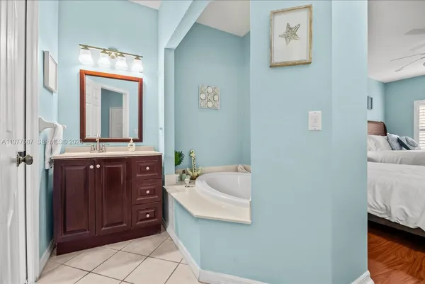 a kitchen with a sink cabinets and wooden floor