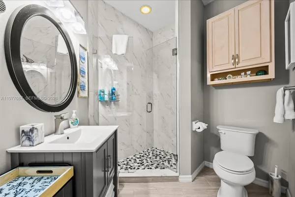 a bathroom with a sink a mirror and a shower