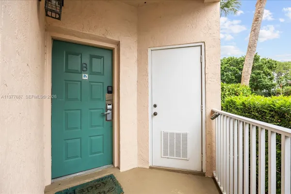 a bedroom with a bed and dresser with large mirror