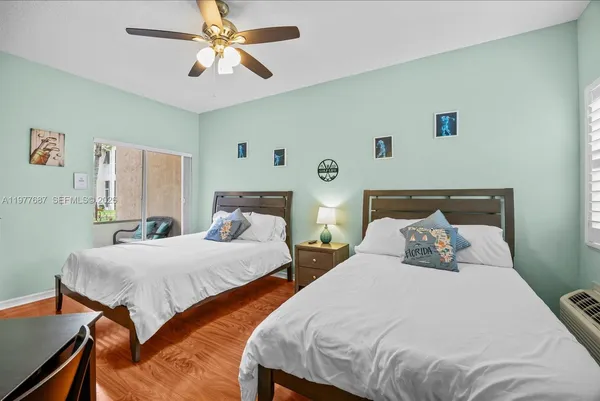 a bedroom with a bed and a lamp on dresser