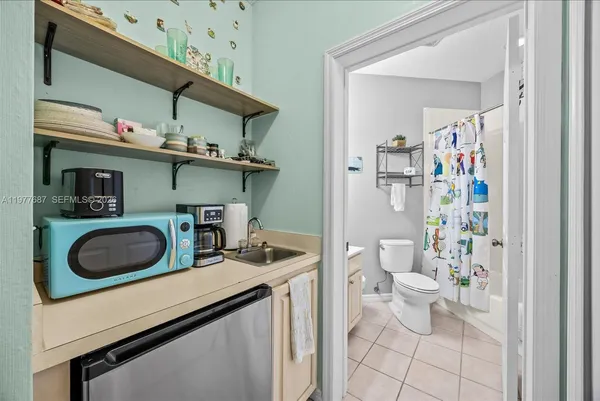 a bathroom with a sink mirror vanity and toilet