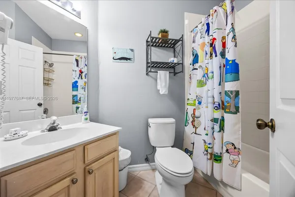 a view of a balcony with chairs and a potted plant