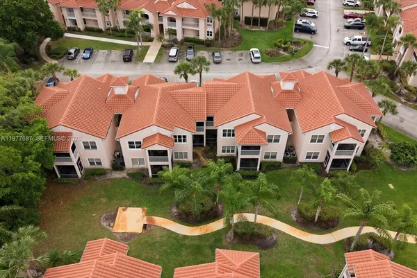 an aerial view of house with yard swimming pool and ocean view