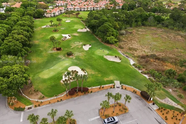 an aerial view of a golf course with parking space