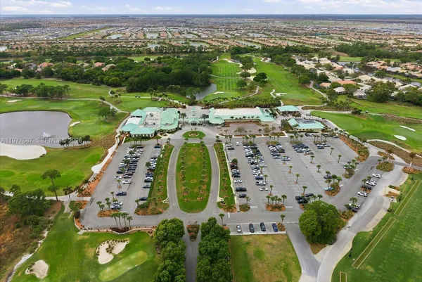 an aerial view of a swimming pool with outdoor seating
