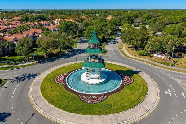 an aerial view of residential houses with outdoor space and trees
