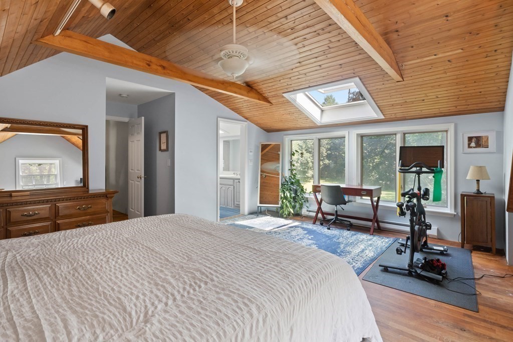 105 Valley Road Boxford, MA 01921 - Photo 19 of 41 a bedroom with furniture large window and wooden floor