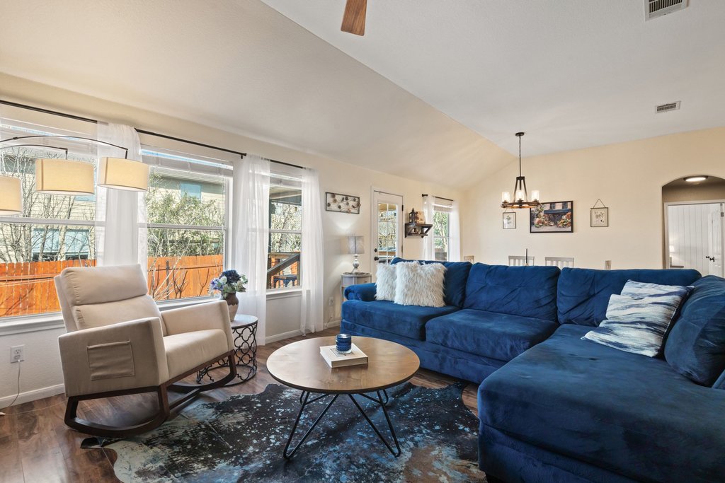 2305 Candle Ridge Trail Georgetown, TX 78626 - Photo 13 of 40 Living area featuring vaulted ceiling, arched walkways, wood finished floors, ceiling fan, and hanging lights