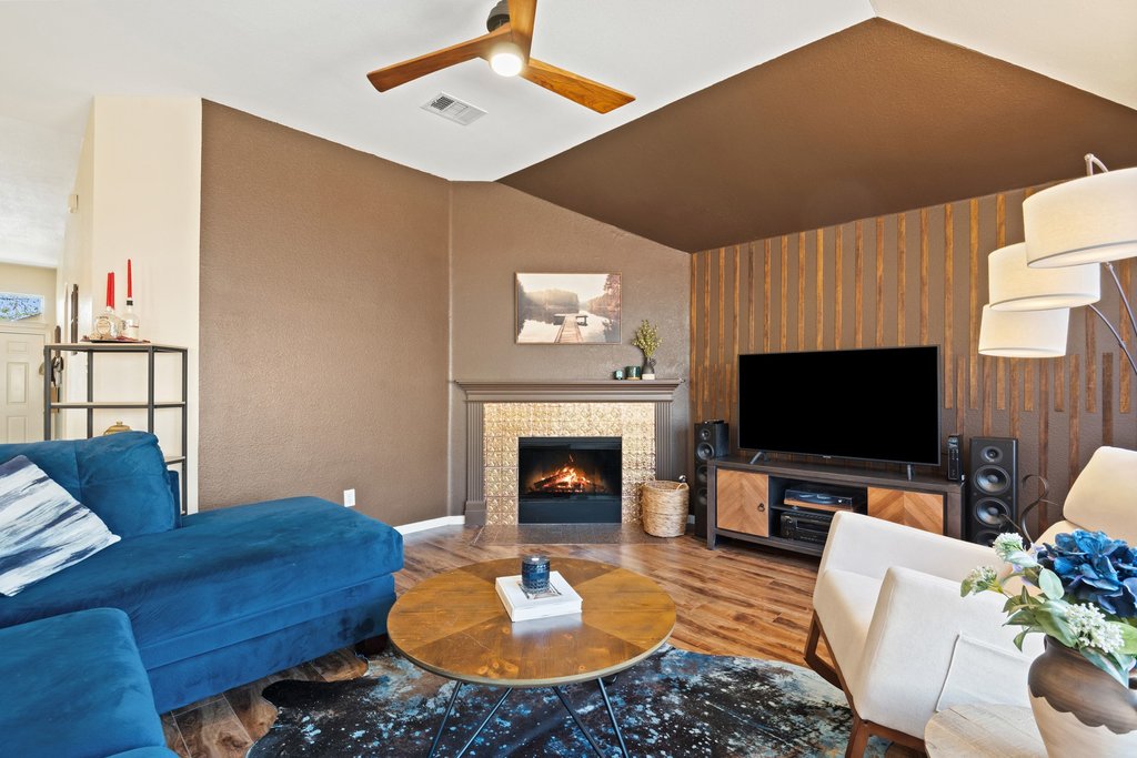 2305 Candle Ridge Trail Georgetown, TX 78626 - Photo 15 of 40 Living room with wood finished floors, ceiling fan, vaulted ceiling, and a tile fireplace