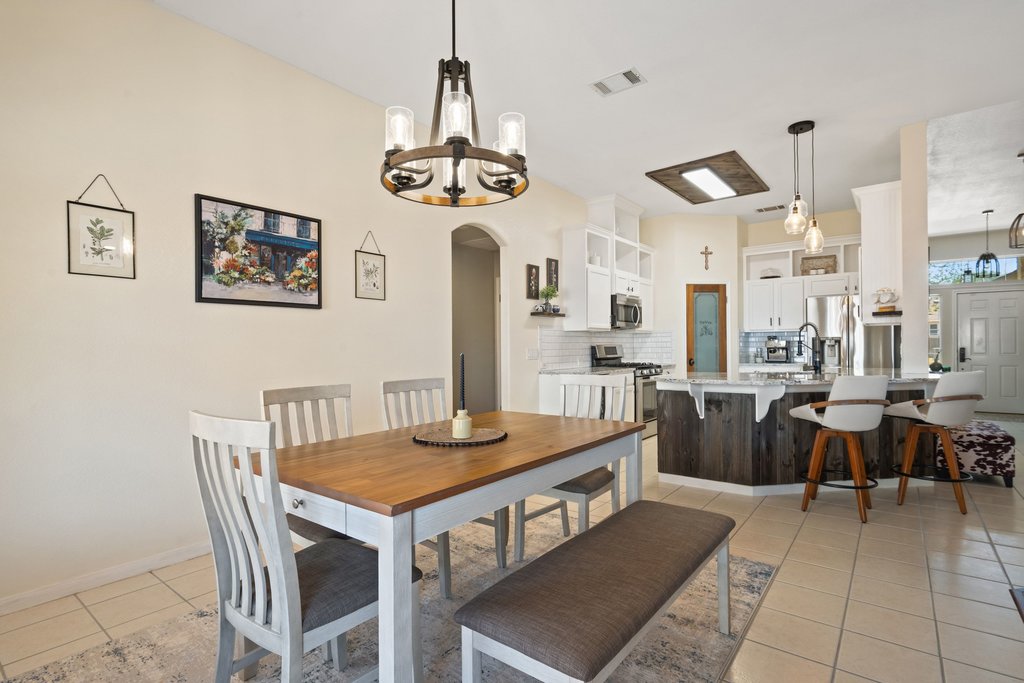 2305 Candle Ridge Trail Georgetown, TX 78626 - Photo 17 of 40 Dining space with arched walkways, light tile patterned flooring, and suspended lighting