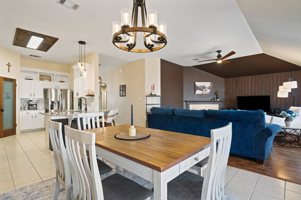 2305 Candle Ridge Trail Georgetown, TX 78626 - Photo 18 of 40 Dining space featuring a ceiling fan, light tile patterned floors, hanging lights, and lofted ceiling