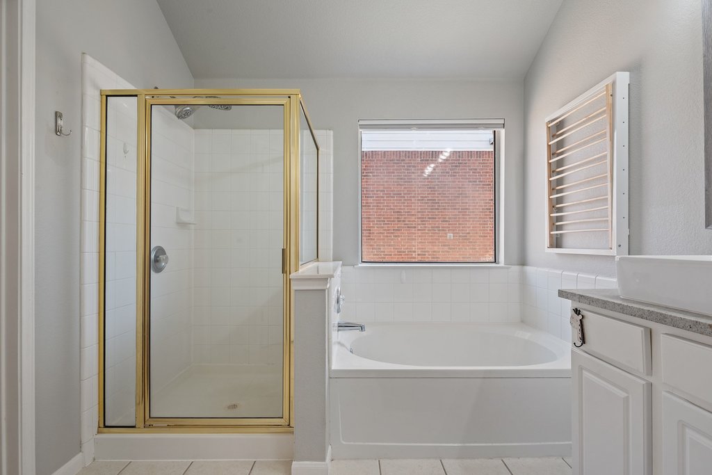 2305 Candle Ridge Trail Georgetown, TX 78626 - Photo 22 of 40 Bathroom with vanity, a bath, a shower stall, and light tile patterned floors