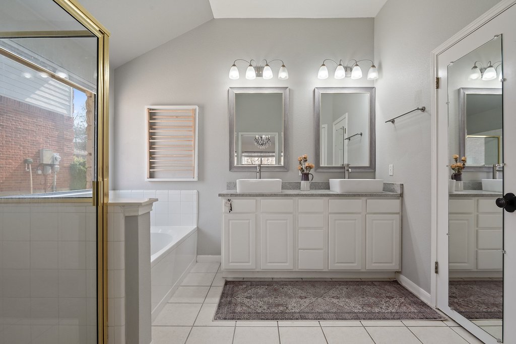 2305 Candle Ridge Trail Georgetown, TX 78626 - Photo 23 of 40 Full bathroom featuring double vanity, a stall shower, a bath, light tile patterned flooring, and lofted ceiling