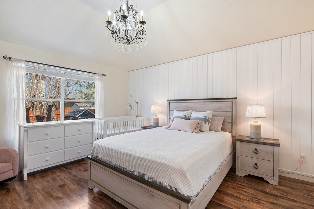 2305 Candle Ridge Trail Georgetown, TX 78626 - Photo 24 of 40 Bedroom featuring dark wood-style flooring and a chandelier