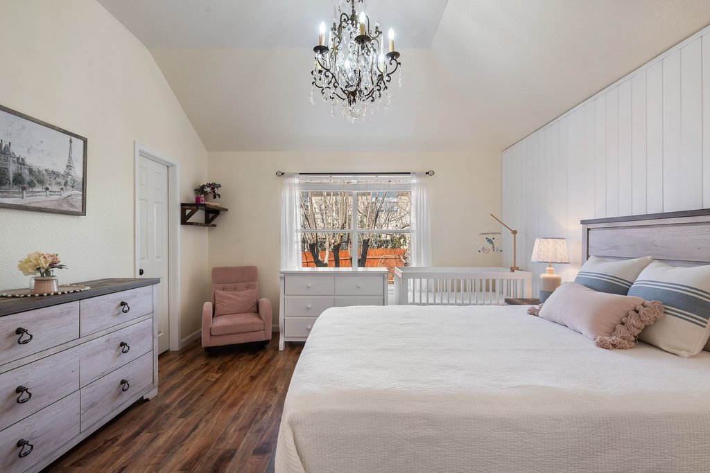 2305 Candle Ridge Trail Georgetown, TX 78626 - Photo 25 of 40 Bedroom with a chandelier, dark wood-type flooring, and vaulted ceiling