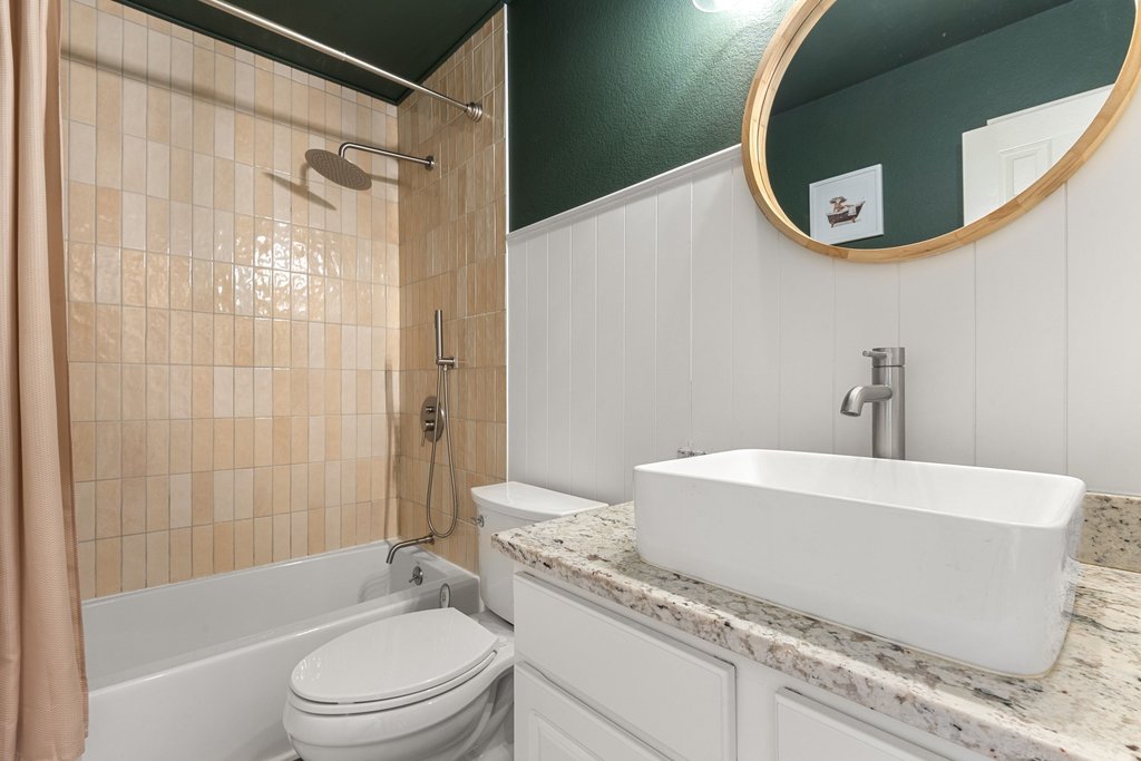 2305 Candle Ridge Trail Georgetown, TX 78626 - Photo 27 of 40 Bathroom with vanity, shower / bath combo, and a wainscoted wall