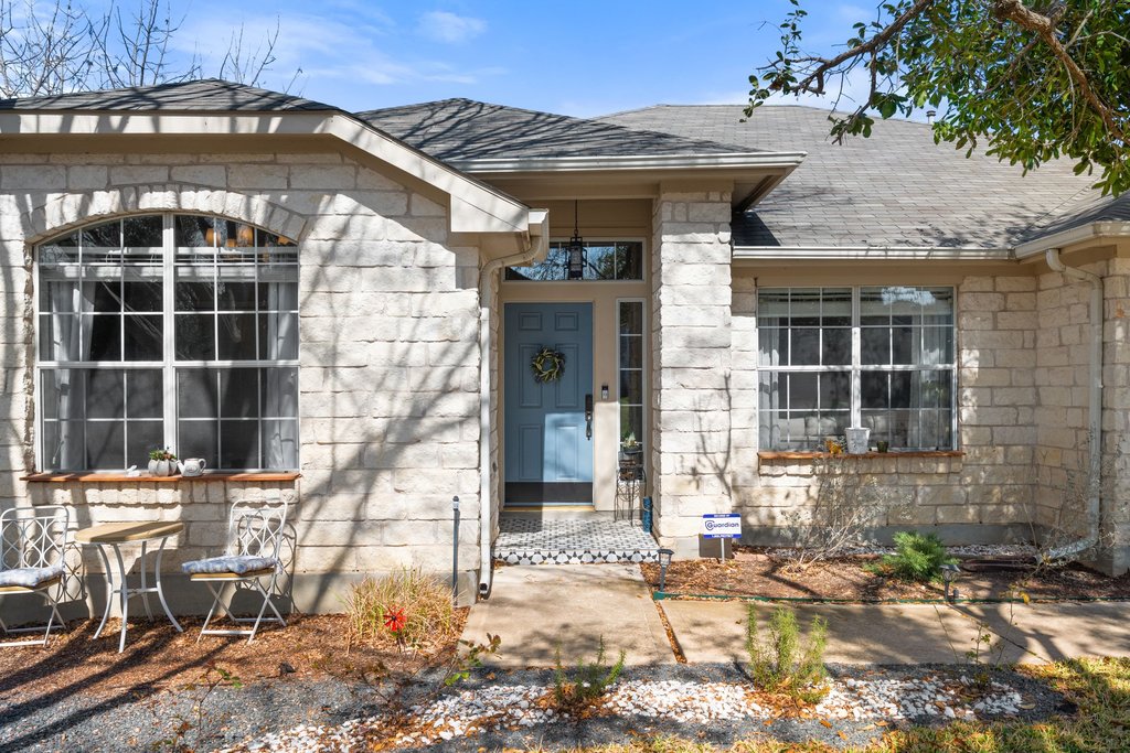 2305 Candle Ridge Trail Georgetown, TX 78626 - Photo 4 of 40 Doorway to property featuring stone siding and a shingled roof