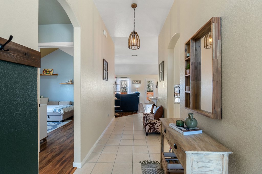 2305 Candle Ridge Trail Georgetown, TX 78626 - Photo 8 of 40 Corridor featuring arched walkways, light tile patterned flooring, and a textured wall