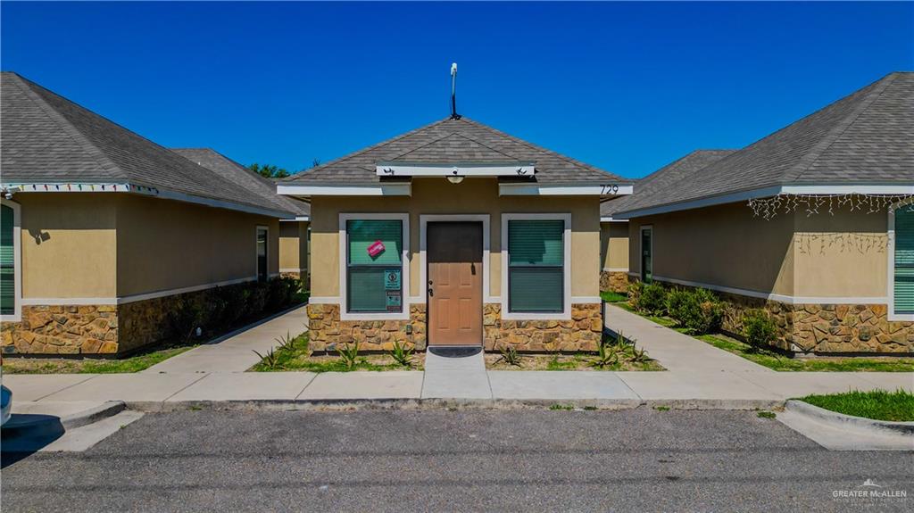 a front view of a house with garden