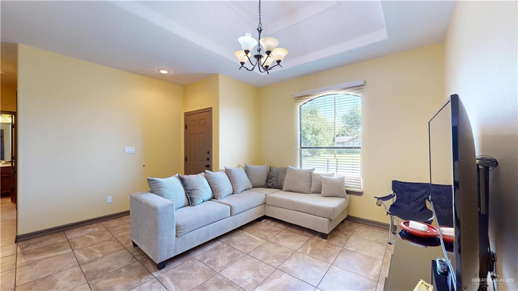 731 North Tower Road Alamo, TX 78516 - Photo 12 of 28 a living room with furniture and a chandelier